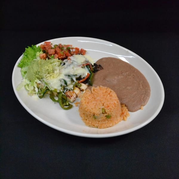 Mr. Sombrero's fajita plate with chicken, peppers, onions, rice, refried beans, guacamole, and pico de gallo.